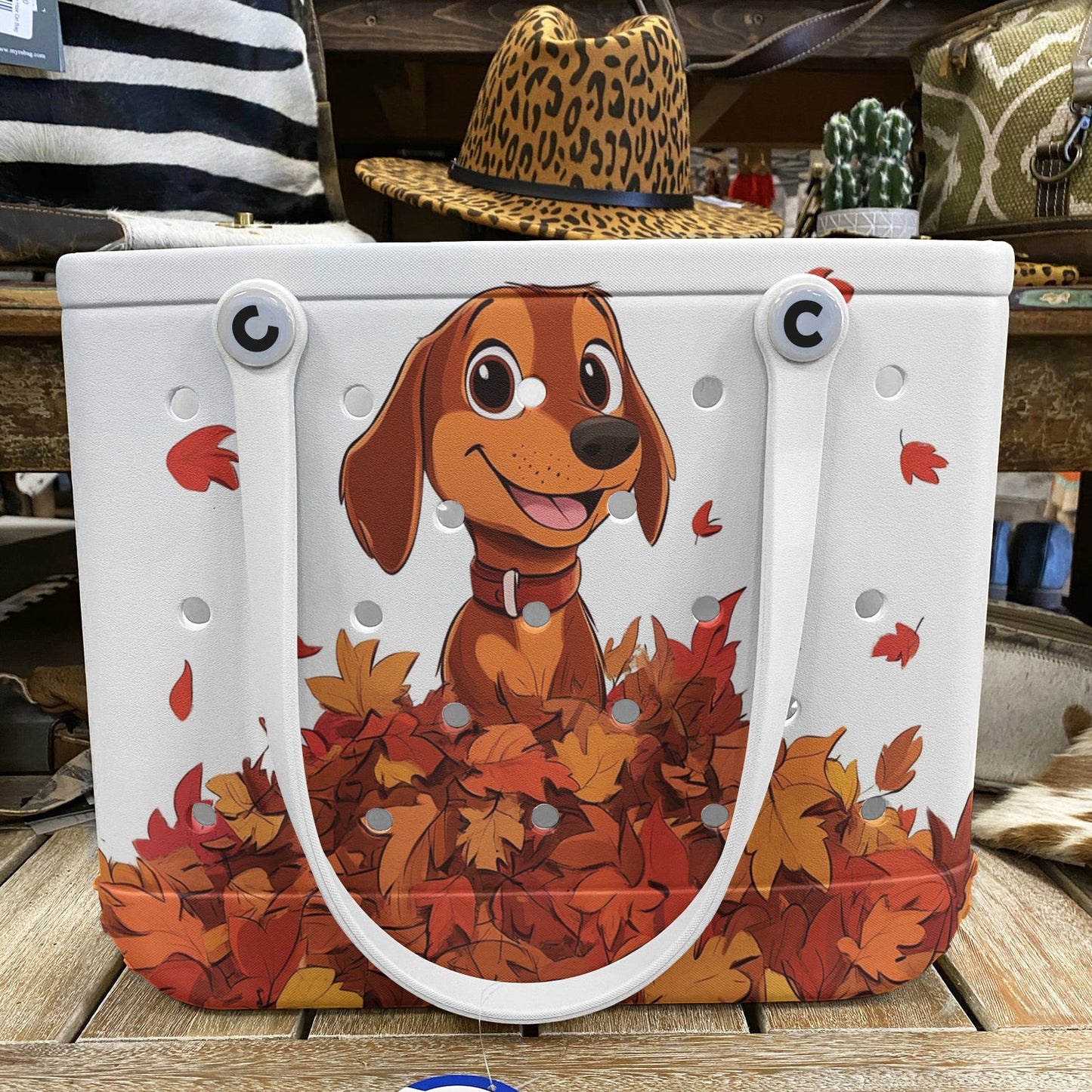 Ceeprints Cee™ Bag Puppy with a pile of autumn leaves