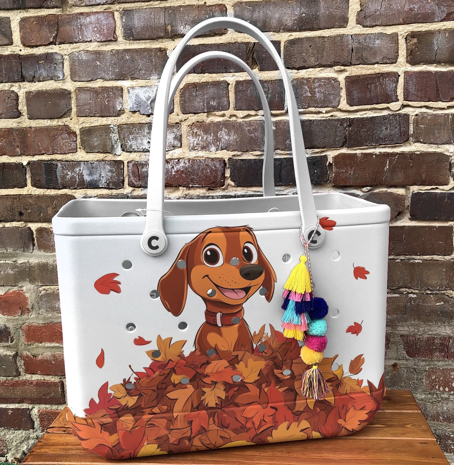 Ceeprints Cee™ Bag Puppy with a pile of autumn leaves