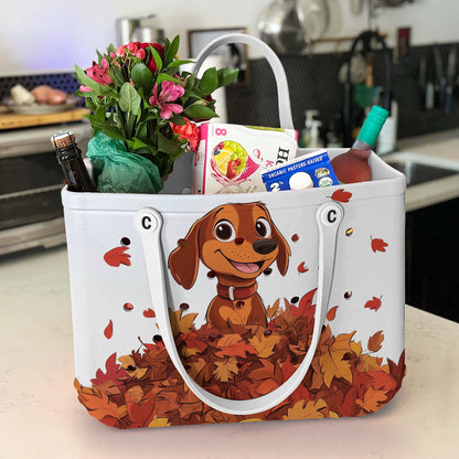 Ceeprints Cee™ Bag Puppy with a pile of autumn leaves