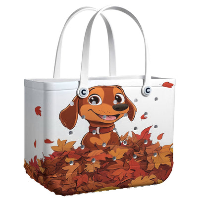 Ceeprints Cee™ Bag Puppy with a pile of autumn leaves